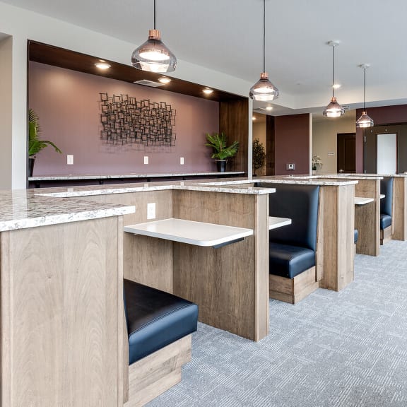 individual work areas in lobby of a building with black leather chairs