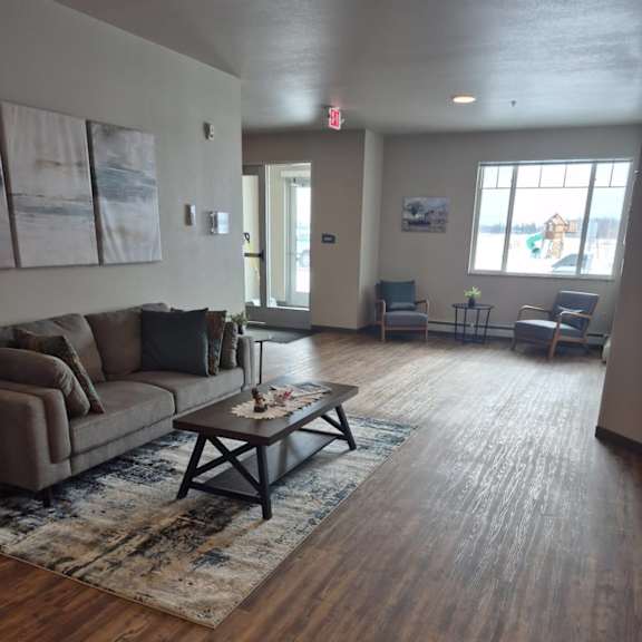 a living room with a couch, chairs, and a coffee table.