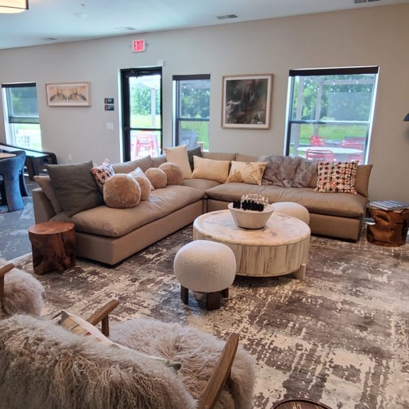 a living room with couches and chairs and a dining room with a piano
