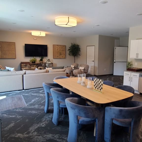 a kitchen and living room with a table and chairs