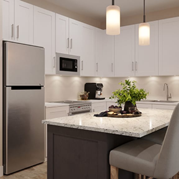 a kitchen with white cabinets and a marble counter top