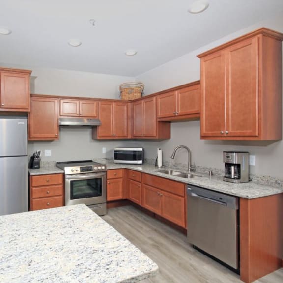 a kitchen with wooden cabinets and stainless steel appliances