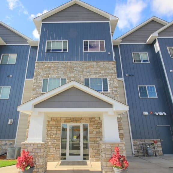 an image of a building with blue siding and a stone facade