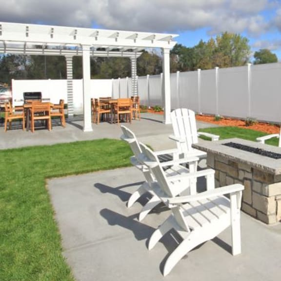 a patio with chairs and tables and a fence