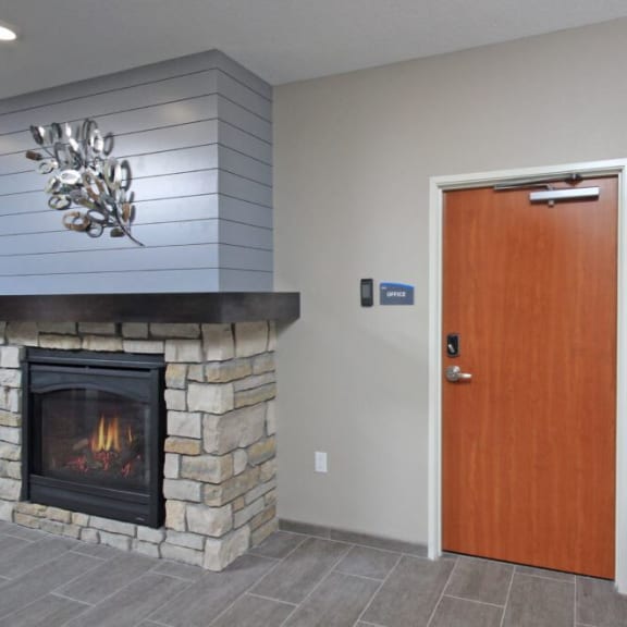 a living room with a fireplace and a wooden door