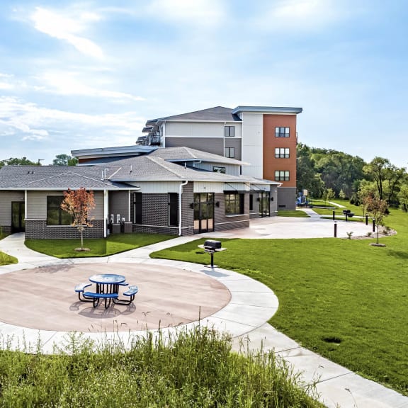 exterior of golden aspen flats including paved pat with grill