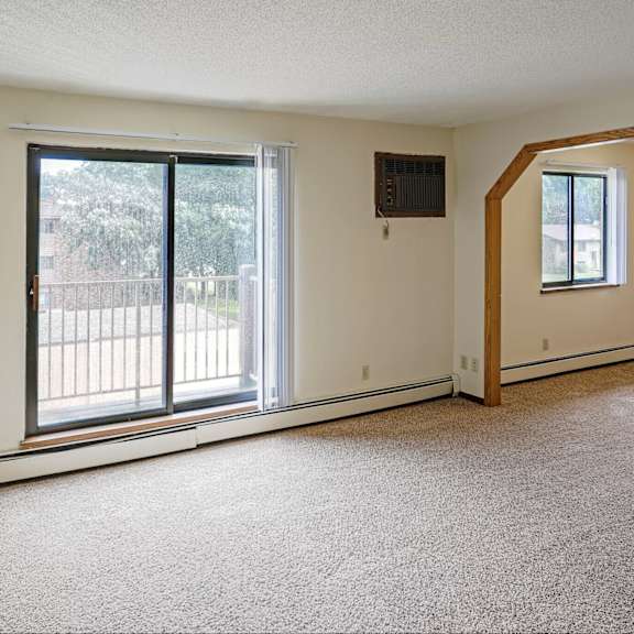 a room with a window and sliding glass doors.