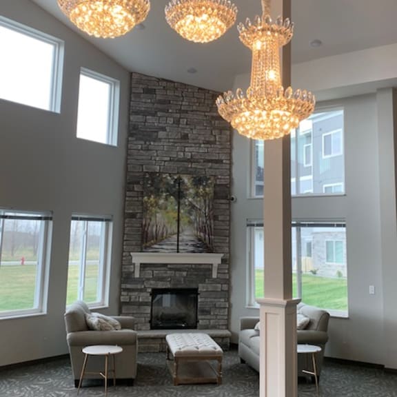 a living room with a fireplace and three chandeliers