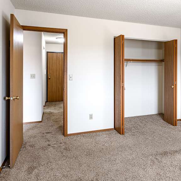 a room with two doors and a carpeted floor.