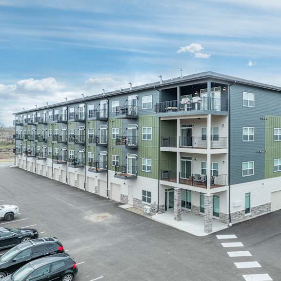 a large apartment building in a parking lot