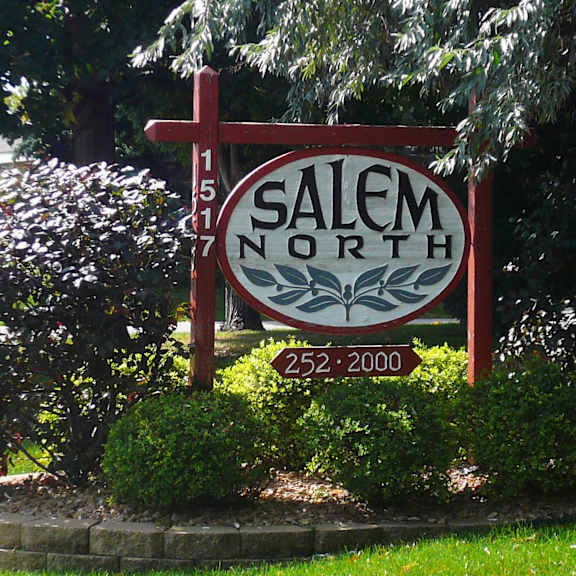 a sign for salem north with a red cross on it.