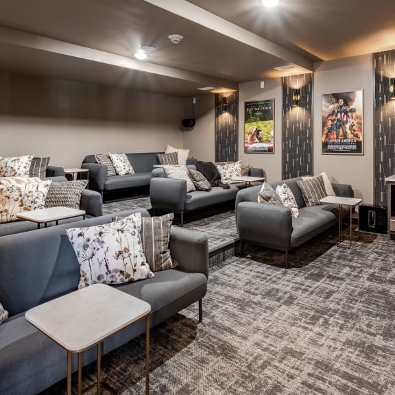 a living room with couches and chairs and a tv