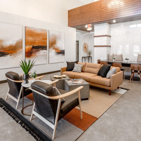a living room with a couch and chairs and a table