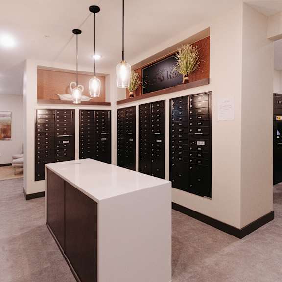 a wine tasting room with a white island in front of a rack of wine bottles