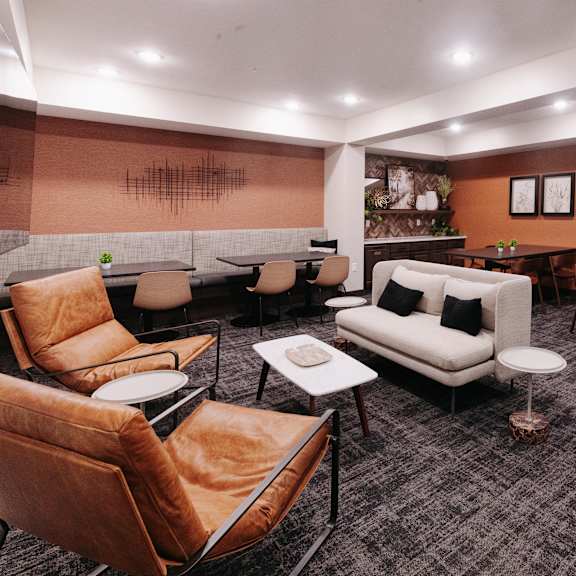 a lounge area with couches and chairs and tables