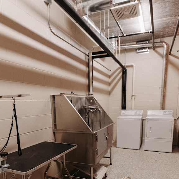 a large stainless steel machine in a room with other appliances
