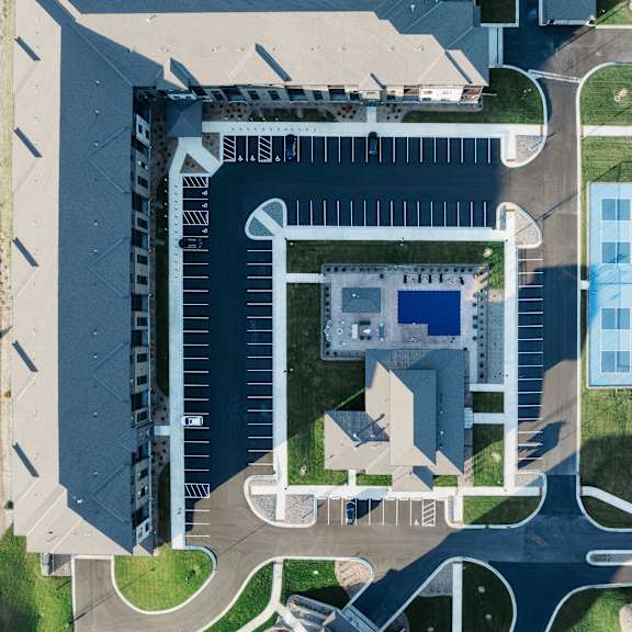 an aerial view of a building on top of a parking lot