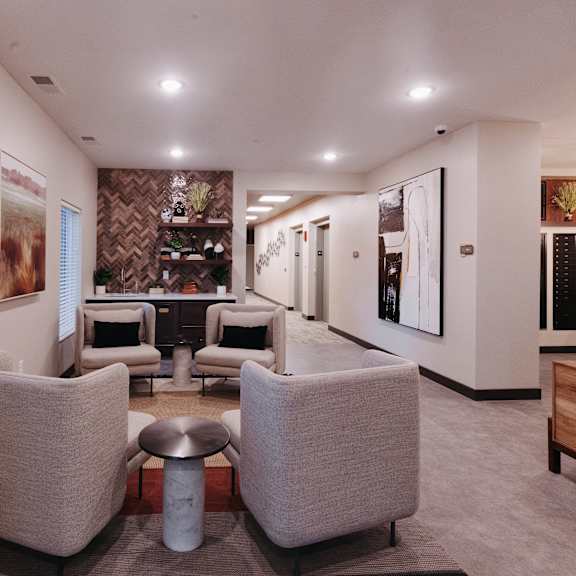a living room with couches and chairs and a bar in the corner