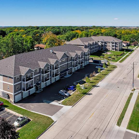 a large building with a parking lot in front of it.