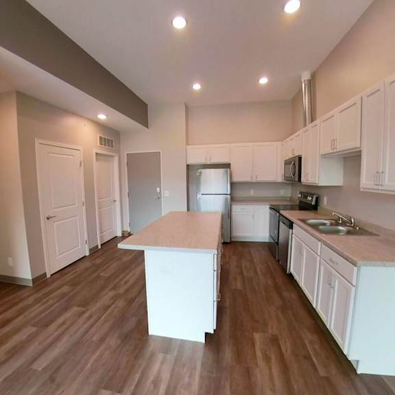 a kitchen with white cabinets and a counter top