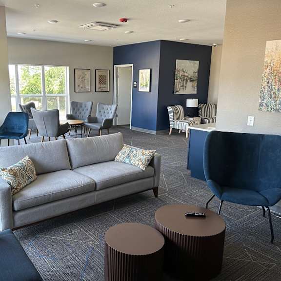 a living room with a couch and tables and chairs
