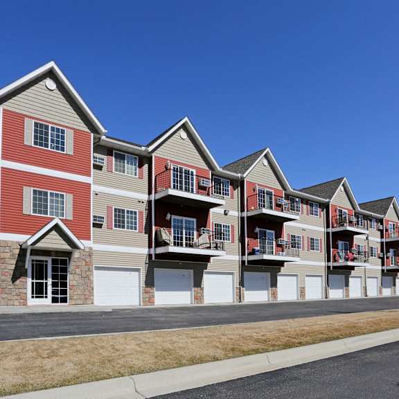 a row of multi-story apartment buildings with garages.