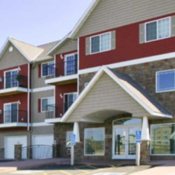 apartment building with red and beige exterior.