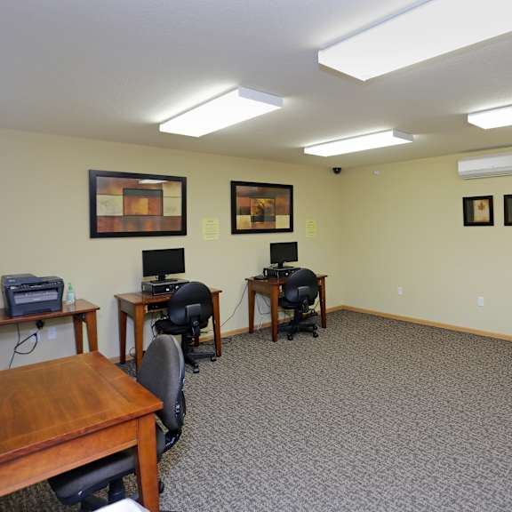 a room with a carpeted floor and a ceiling fan.