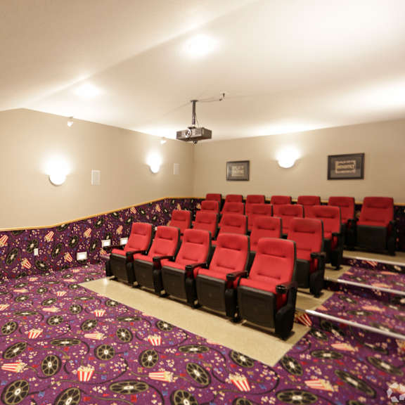 a room with a carpet of stars and stripes and red chairs.
