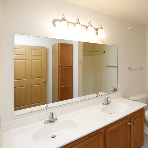 a bathroom with a white sink and a toilet.
