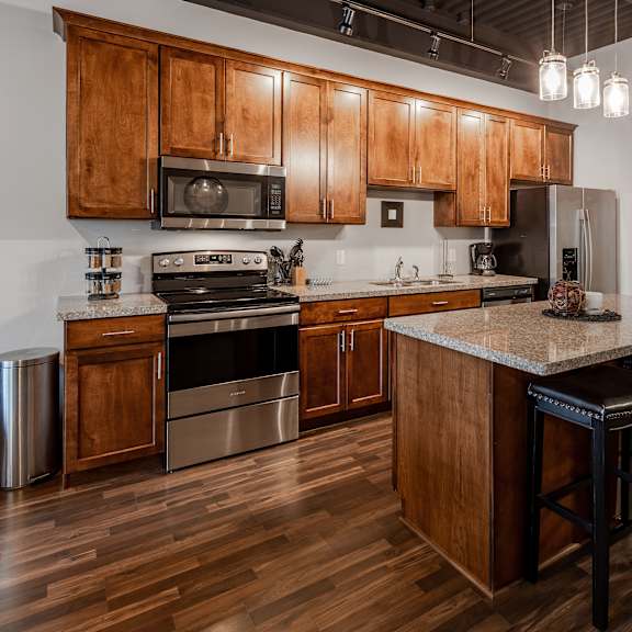 a kitchen with wooden cabinets and stainless steel appliances