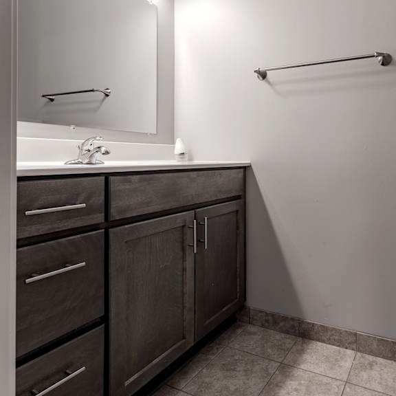 a bathroom with a toilet and a sink and a mirror