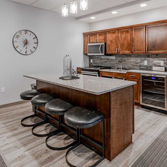 a kitchen with a center island with four stools
