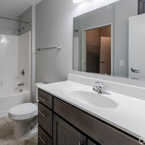 an empty bathroom with a sink toilet and shower
