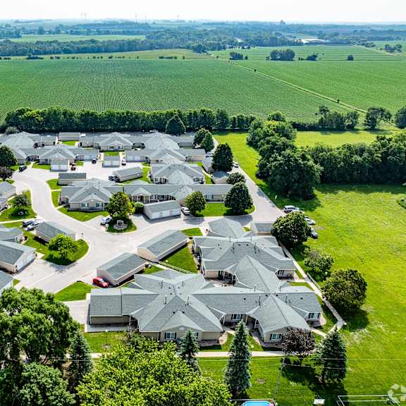 a bird's eye view of a residential area with houses and greenery.