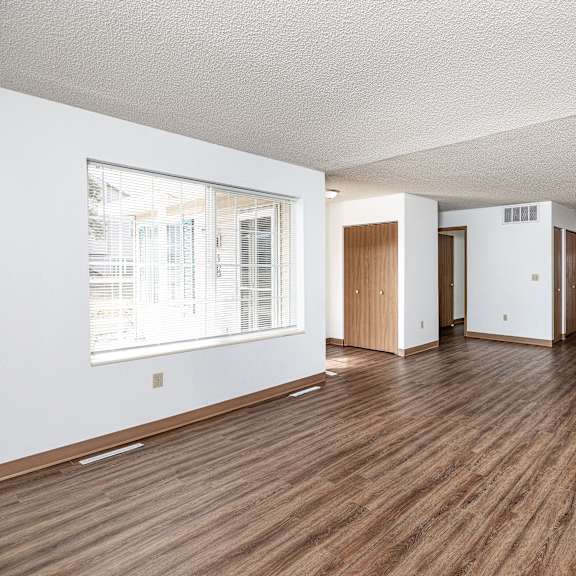 a room with wooden floors and white walls.
