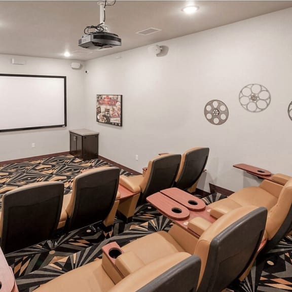 a conference room with a projector screen and chairs