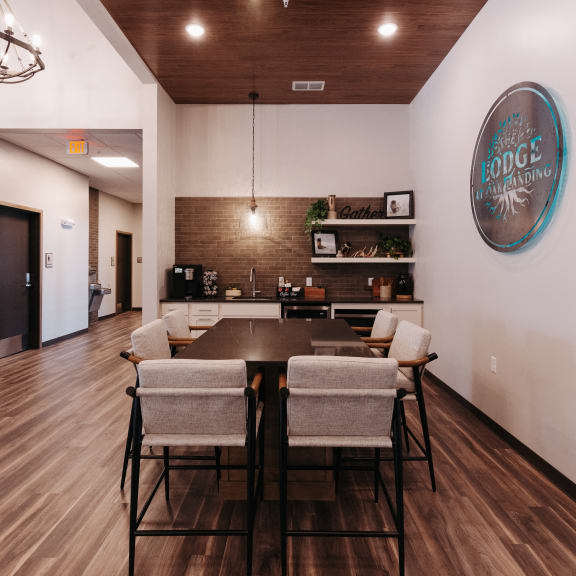 a dining room with a table and chairs and a wall with a sign on it