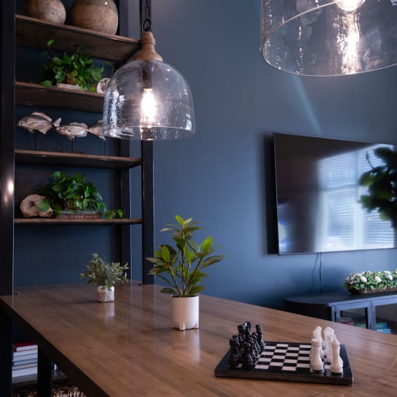 a dining room with a wooden table and two lights