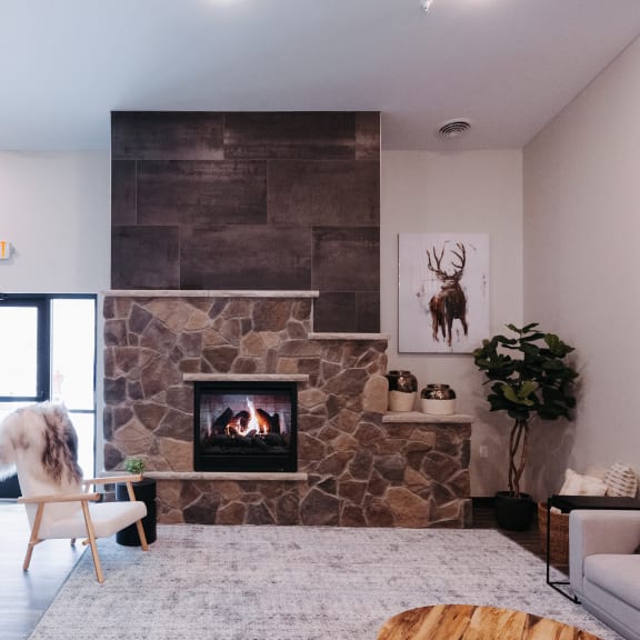 a living room with a stone fireplace and a white couch