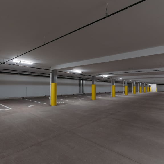 a parking garage with yellow pillars and white walls