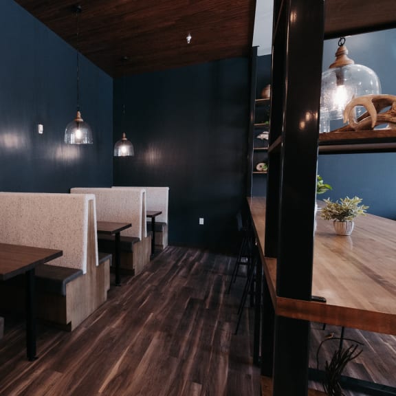 a dining room with blue walls and wooden tables and chairs