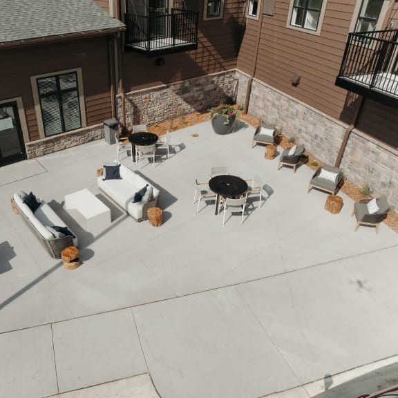 an aerial view of an outdoor patio with tables and chairs