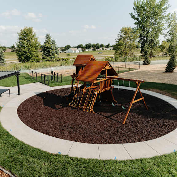 a playground with a swing set in a park