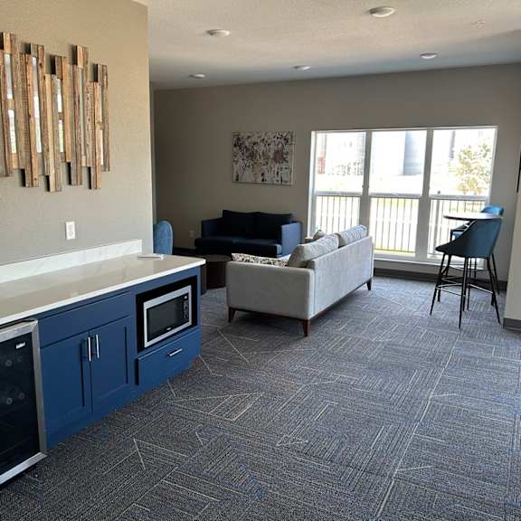 a view of a living room with a kitchen and a couch