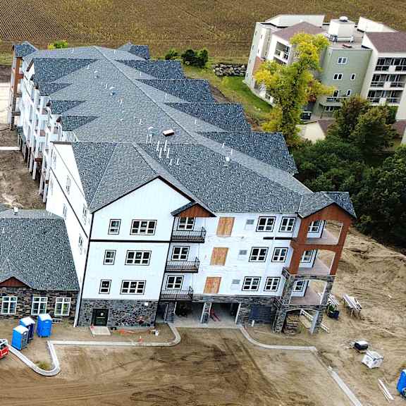 a large building complex with a playground in the middle.