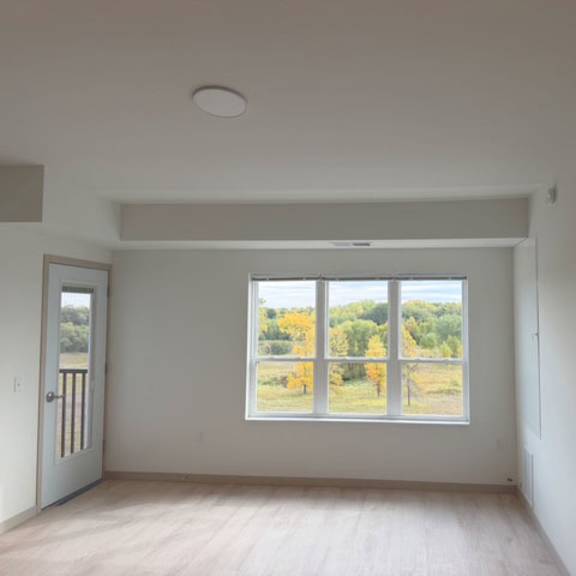 a room with a large window overlooking a field.