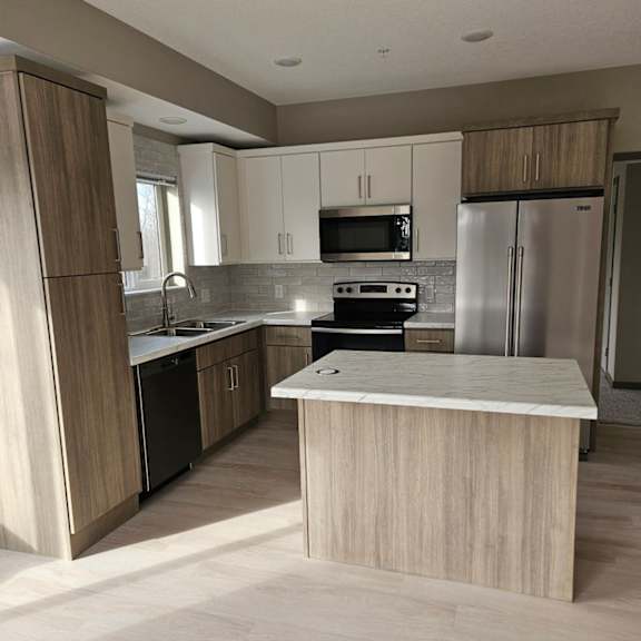 a kitchen with a white island in the middle of it.