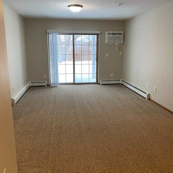 a room with a window and a wall on the left side.