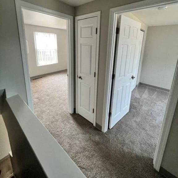 an empty living room with an open door